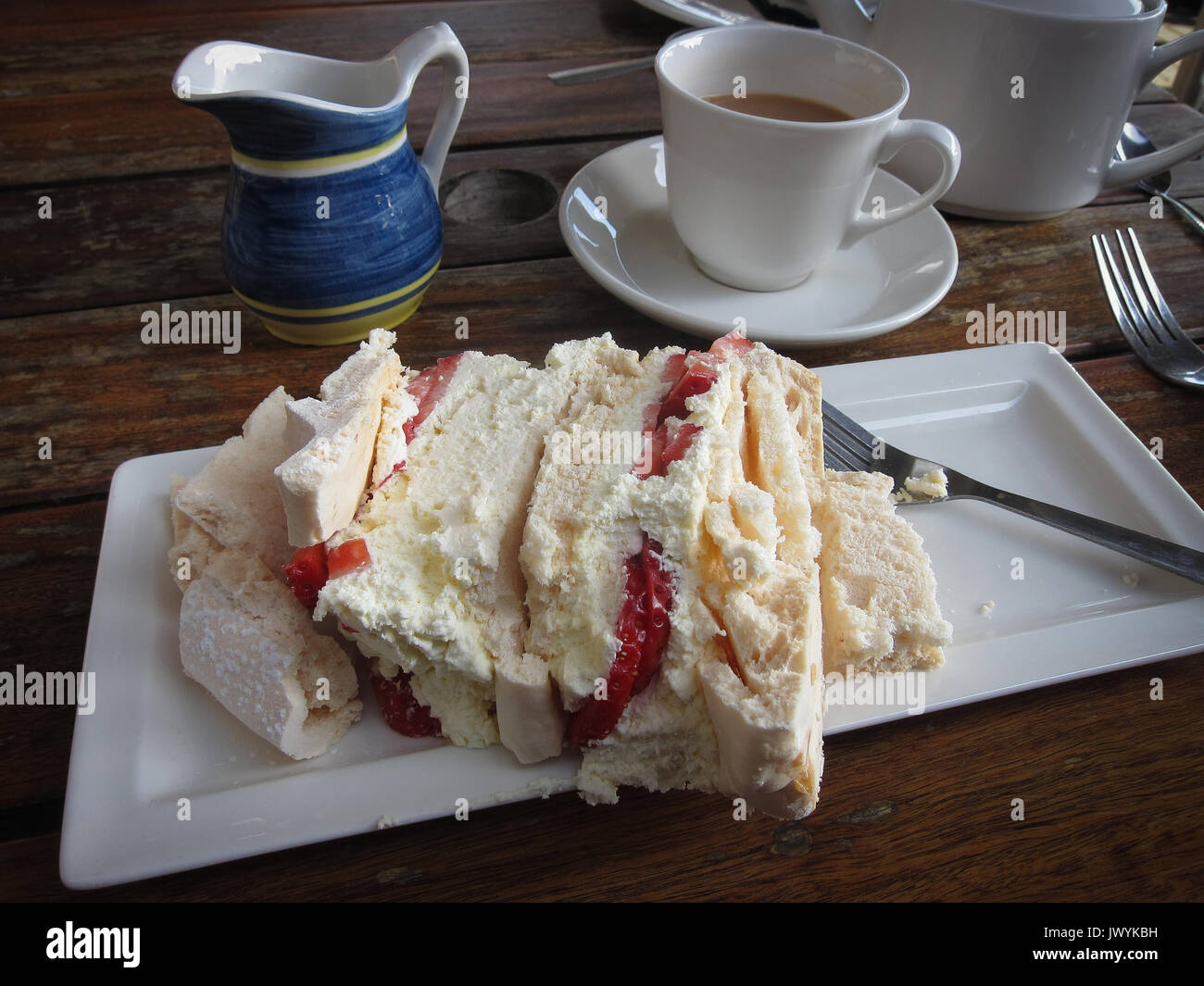 Delicious meringue, cream and strawberry cake served for an afternoon tea at Battlers Green Farm's The Bull Pen Tea Room, near Radlett, Herts England. Stock Photo