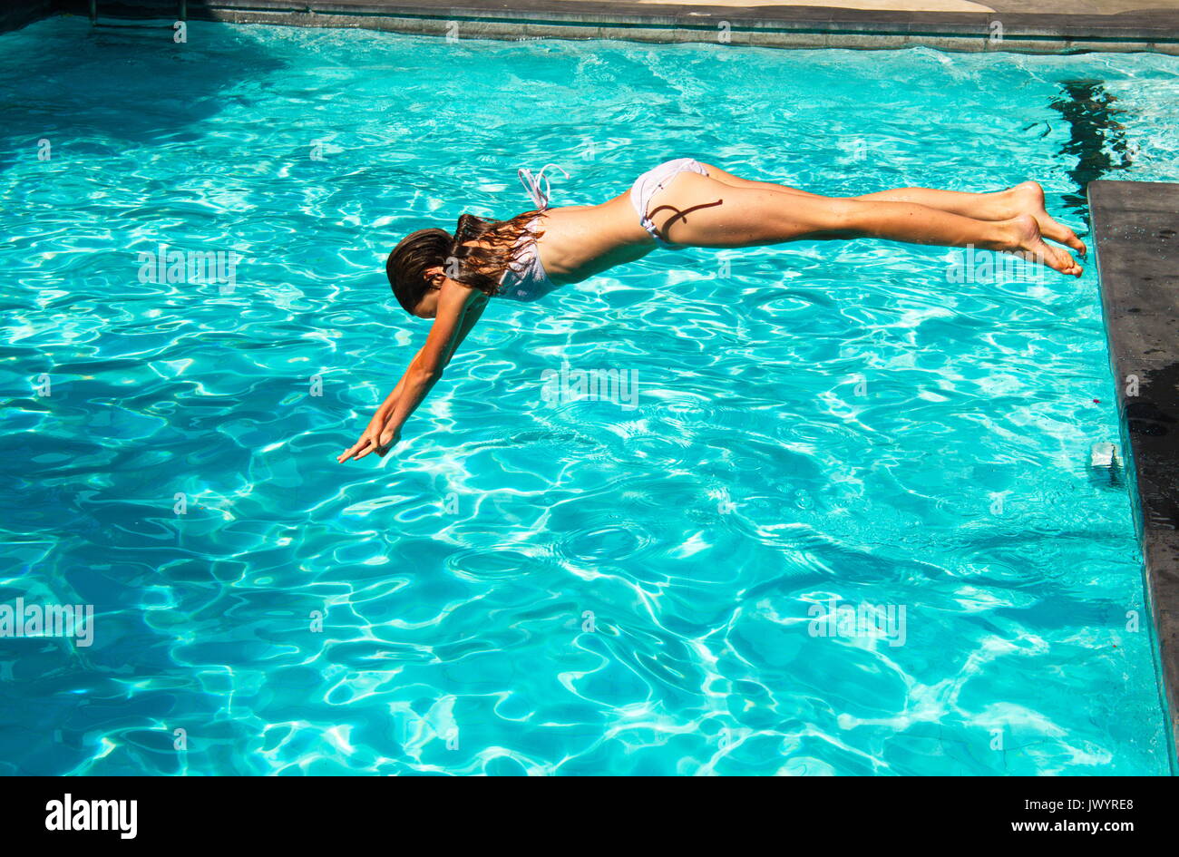 Young woman jumping in Water/Pool Stock Photo