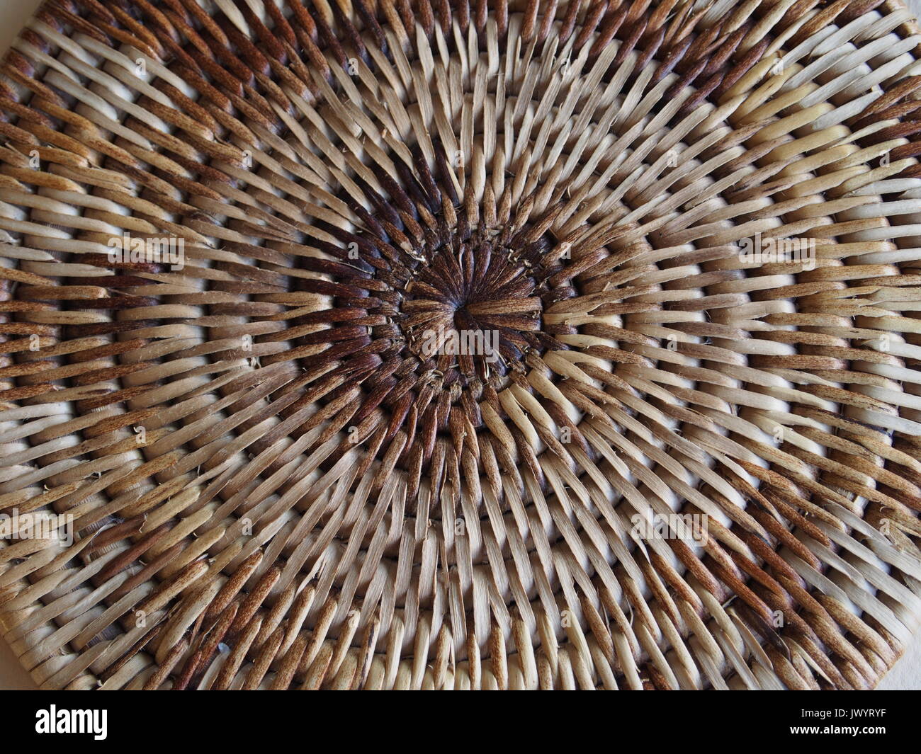 Detail of a Papua New Guinea woven cane Buka place mat. 17 cm diameter. Stock Photo