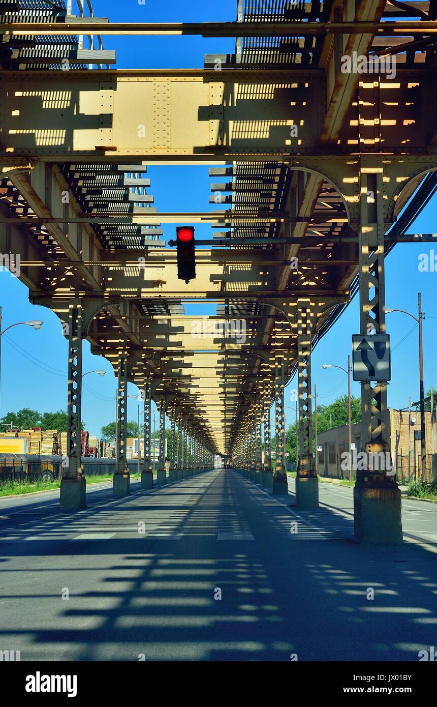 The elevated structure hovering above and about Lake Street in Chicago stretching to a vanishing point. Chicago, Illinois, USA. Stock Photo