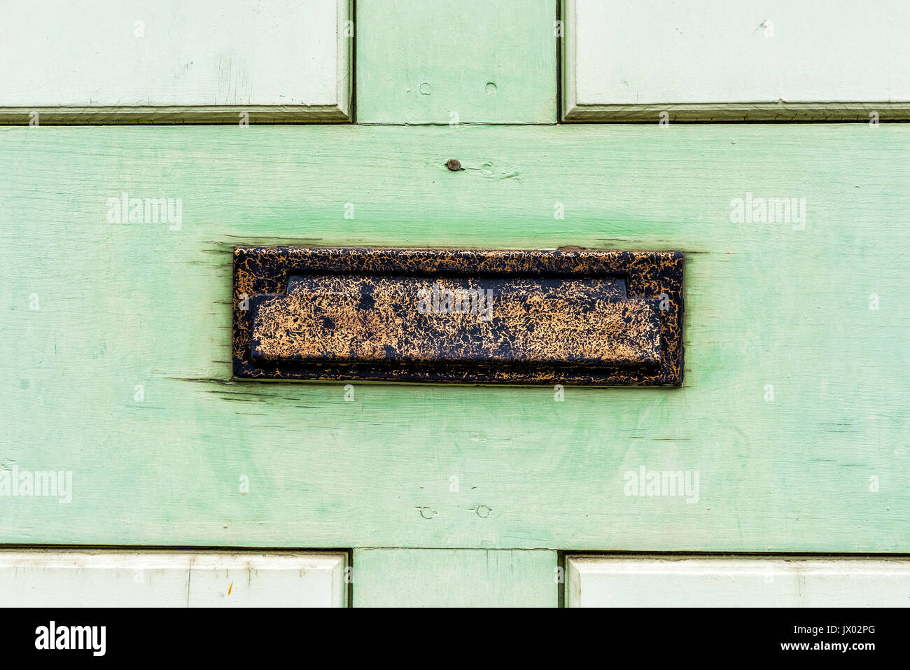 Vintage metal mail slot in door with painted green wood Stock Photo Alamy