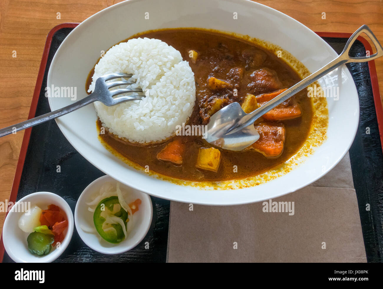 Japanese curry, with melted beef, carrots, potatoes and white rice in a white bowl Stock Photo
