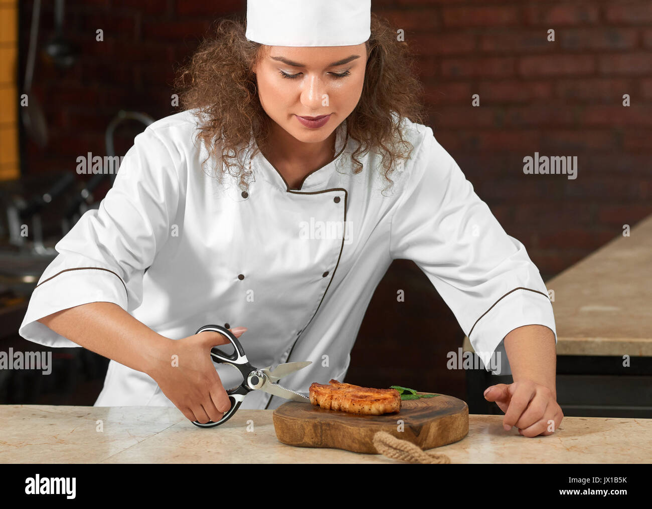 Professional chef cutting chicken steak with scissors Stock Photo Alamy