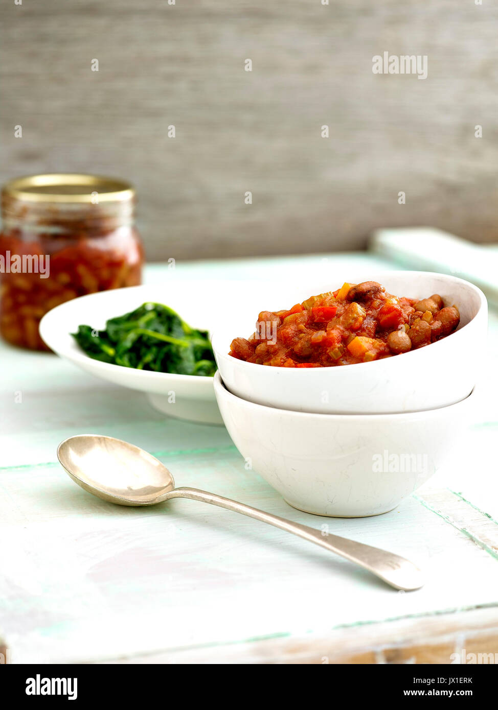 pan wilted spinach in small frying pan and tomato relish Stock Photo