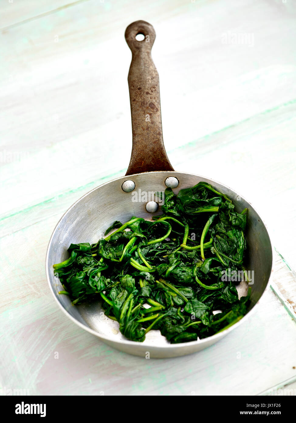 pan wilted spinach in small frying pan Stock Photo