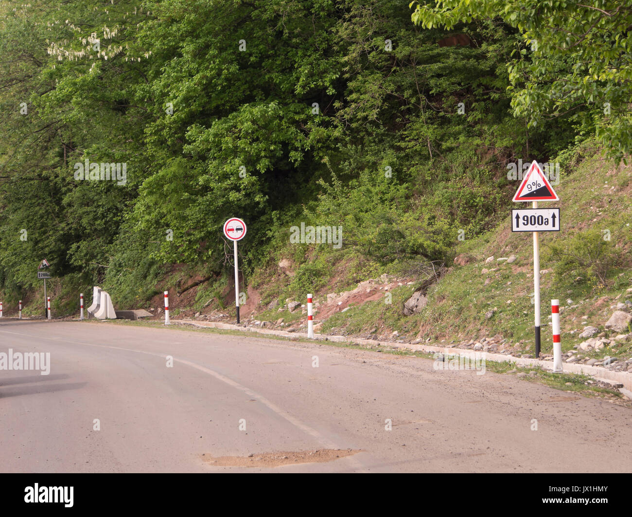 Sightseeing in Georgia can be challenging for the driver, road signs warning for 9 % steep decline near the Gelati monastery Stock Photo