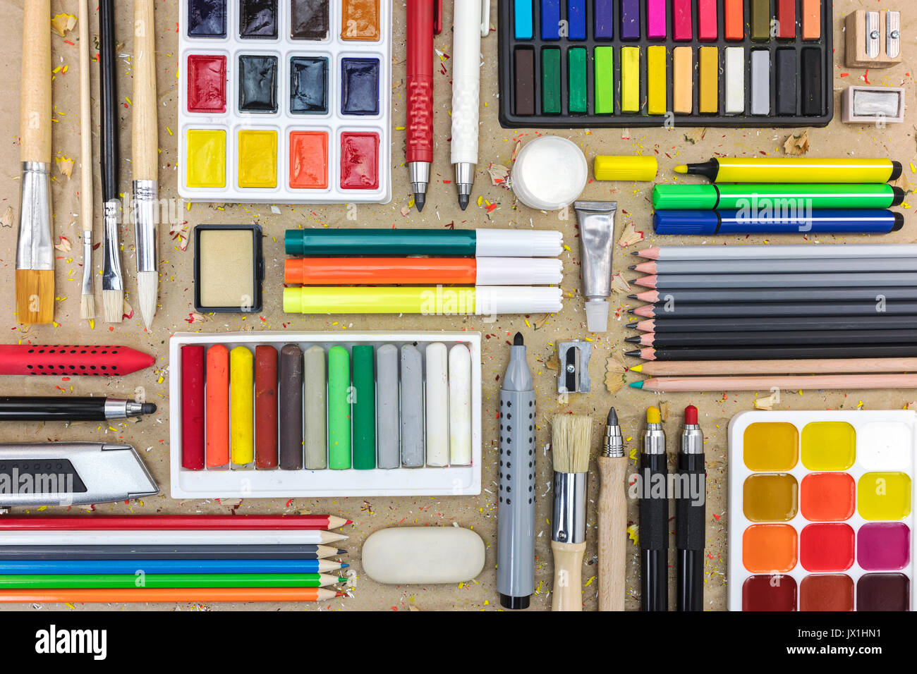 set of different drawing tools on brown craft paper background with