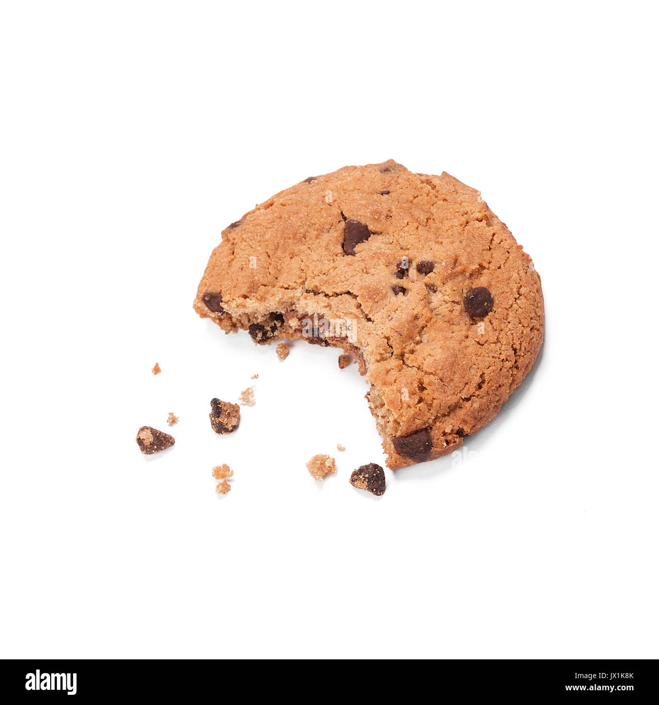 Single round chocolate chip biscuit with crumbs and bite missing, isolated on white from above. Stock Photo
