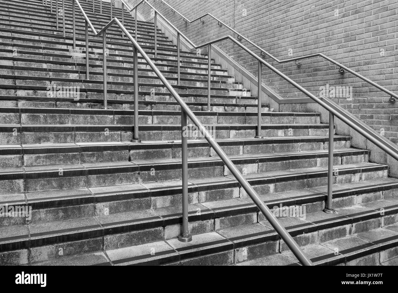 Concrete flight of steps & steel handrails. For urban life, climbing career ladder, corporate ladder, getting on property ladder, staircase to nowhere Stock Photo