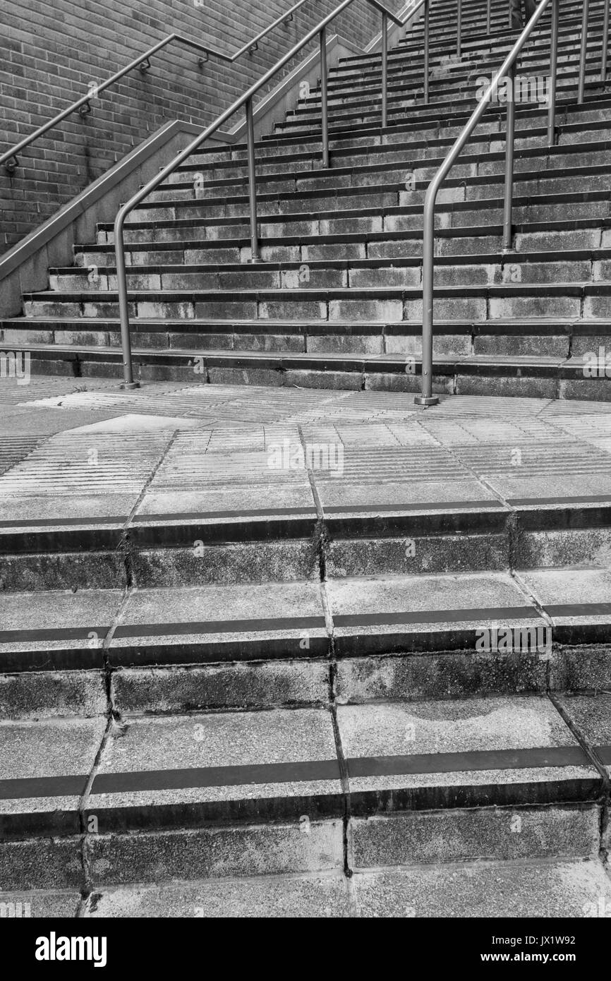 Concrete flight of steps & steel handrails. For urban life, climbing career ladder, corporate ladder, getting on property ladder, staircase to nowhere Stock Photo