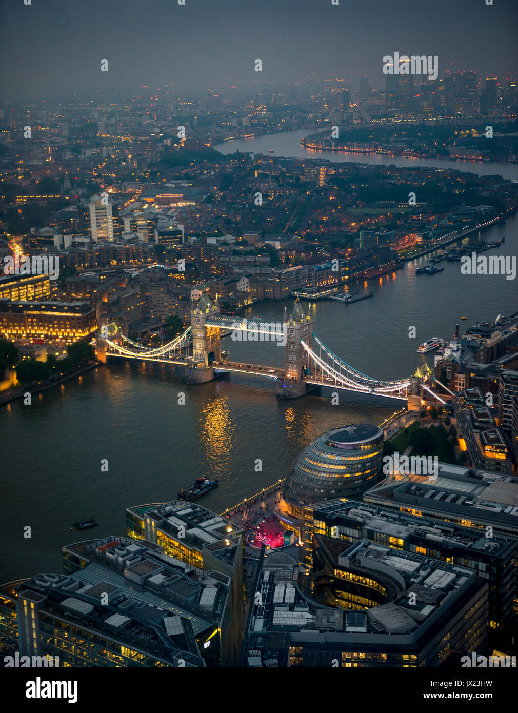 View of River Thames towards Canary Wharf, illuminated Tower Bridge with London City Hall, night shot, aerial view, London Stock Photo
