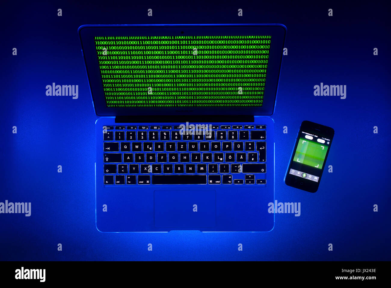 Laptop, symbolic image, cybercrime, computer crime, computer hacker, data security, smartphone tracking Stock Photo