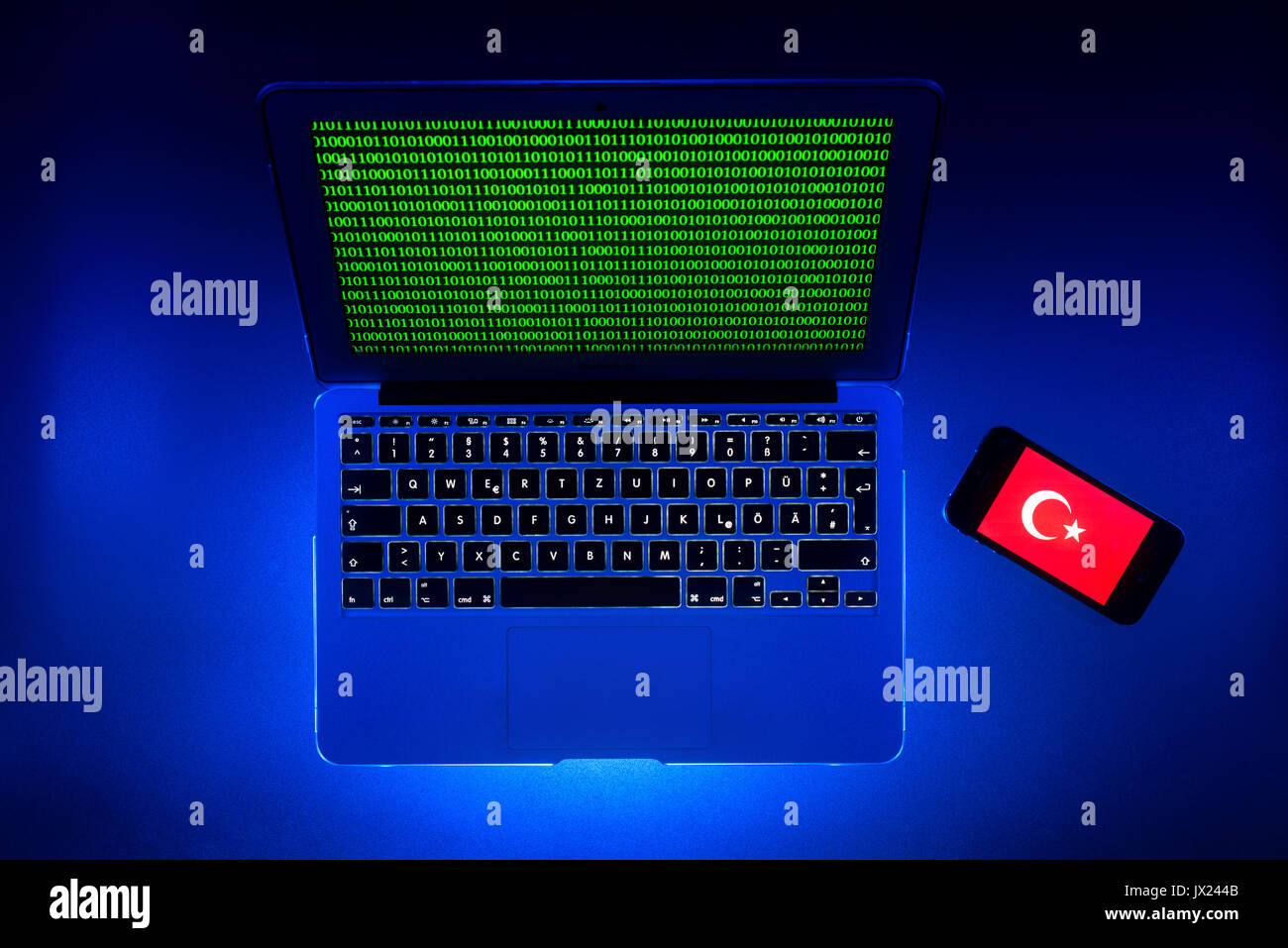 Laptop, symbolic image, cybercrime, computer crime, computer hacker, data security, Turkish flag on smartphone Stock Photo