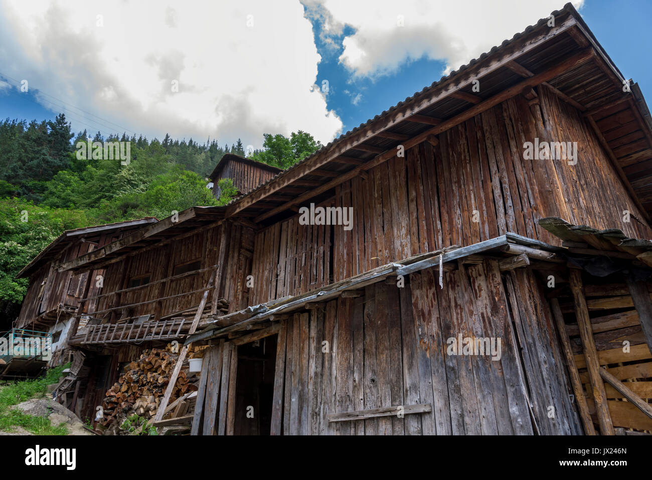 Old wooden houses on a rural landscape background in summer Stock Photo ...