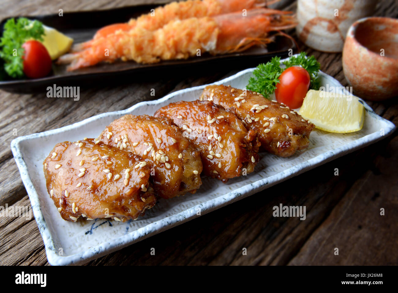 Fried chicken wing with spicy sauce in Japanese style or Tebasaki wing serve in izakaya restourant. Stock Photo