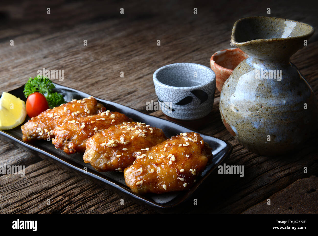 Fried chicken wing with spicy sauce in Japanese style or Tebasaki wing serve in izakaya restourant. Stock Photo