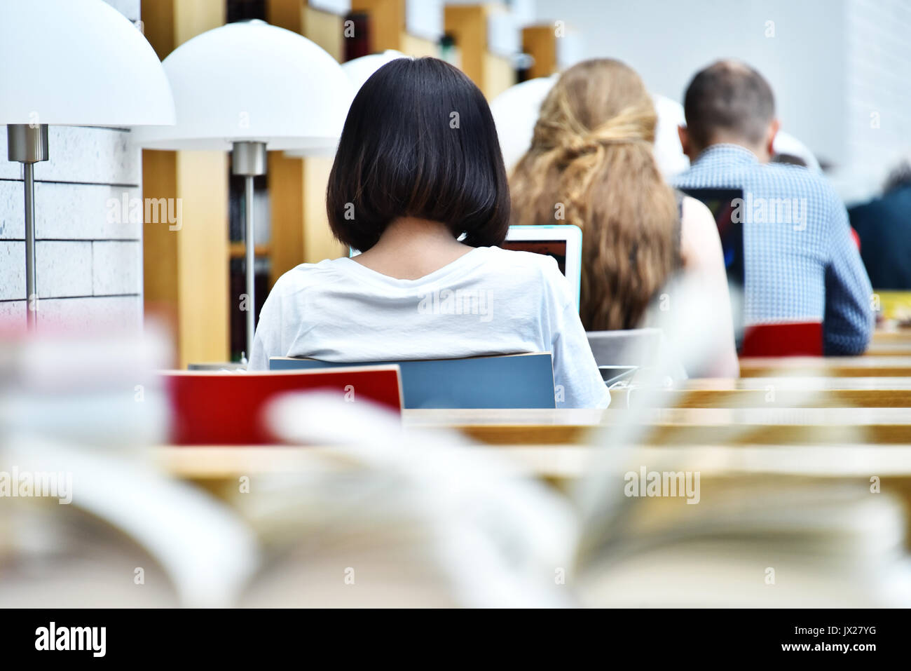 Students reading in a public library. Stock Photo