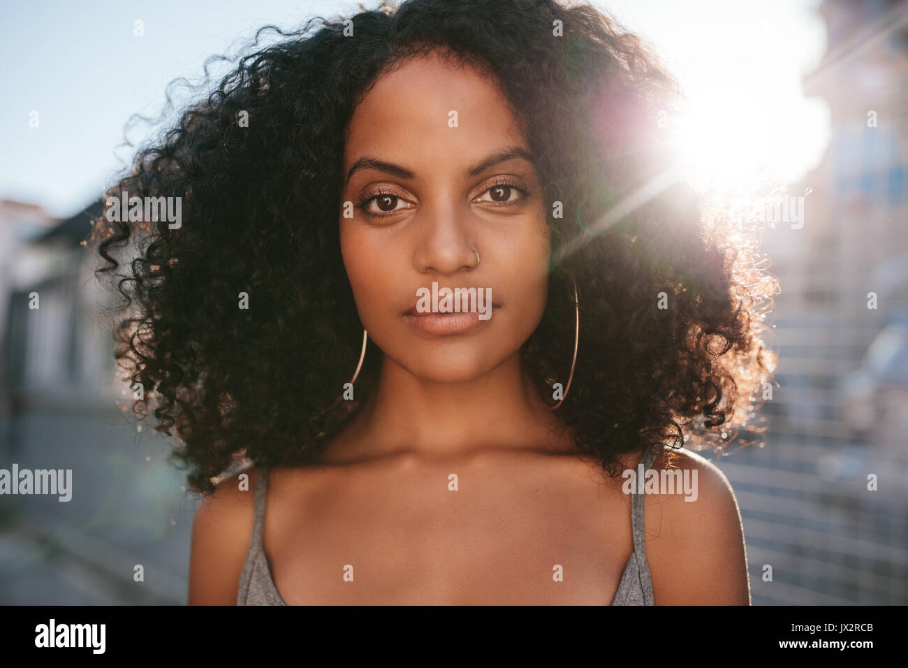 Close up portrait of beautiful young african woman with curly hair ...