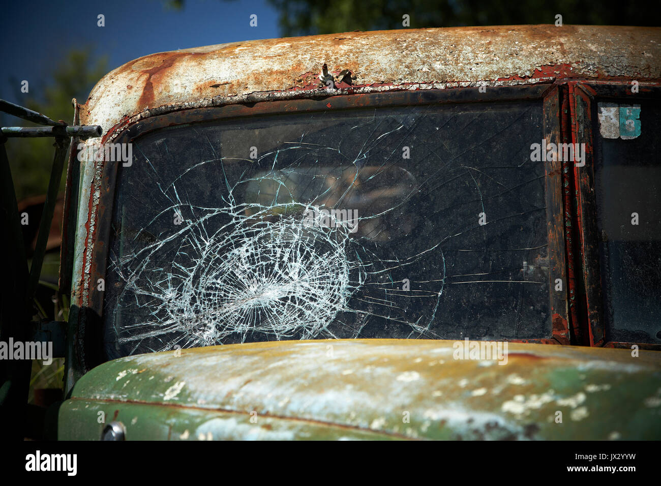 rusting old pick up truck dumped in scrub ground Stock Photo