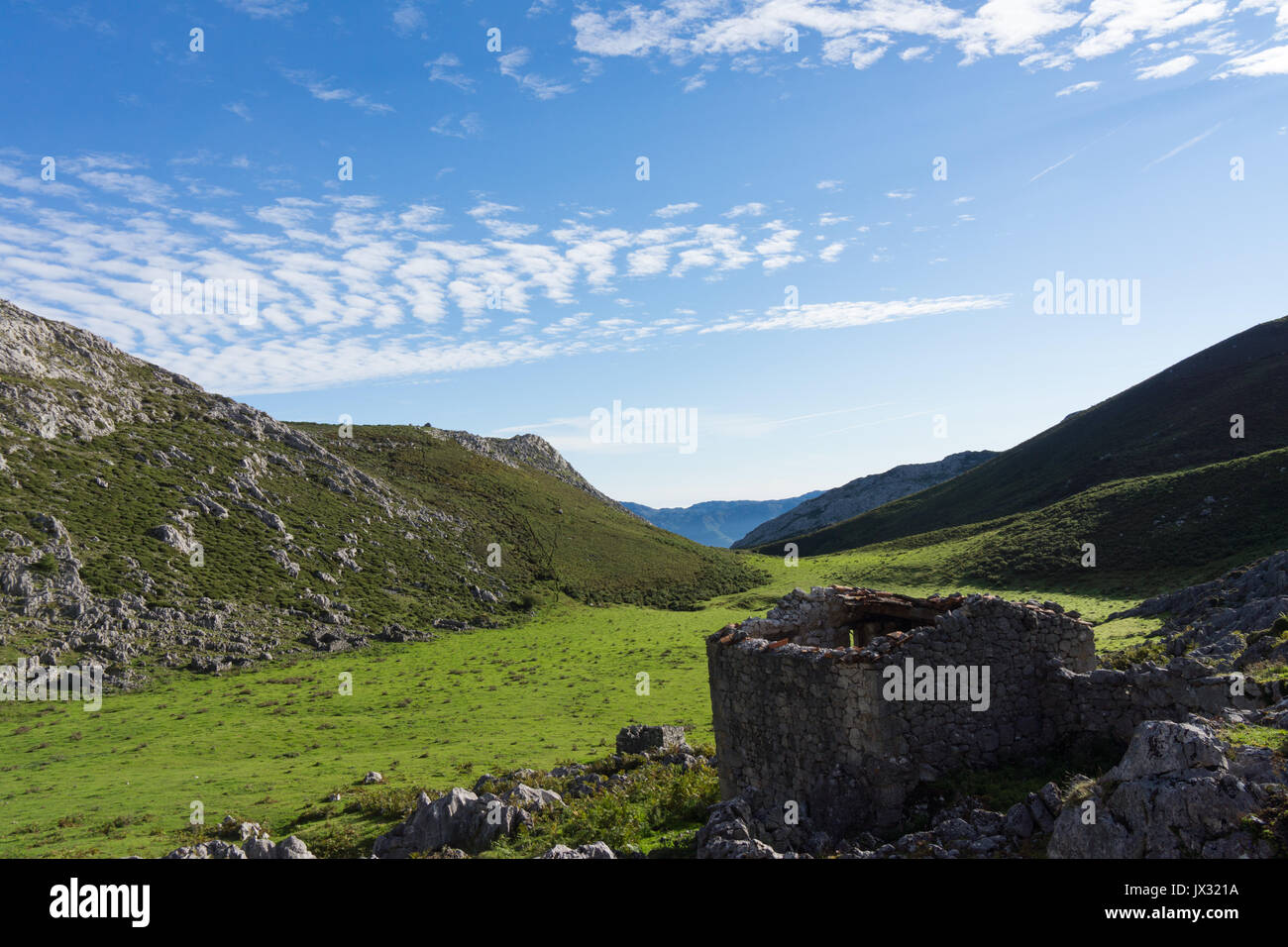 Derelict buildings and old mountain homesteads in a high pasture in the picos de europa mountians.  Brañarredonda. Stock Photo
