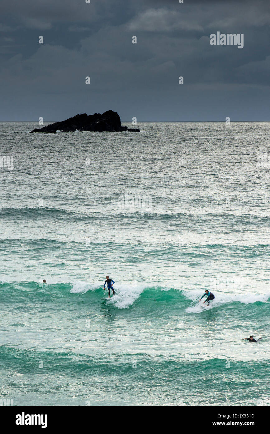 Surfing UK. Surfers riding a wave at Fistral in Newquay, Cornwall Stock ...