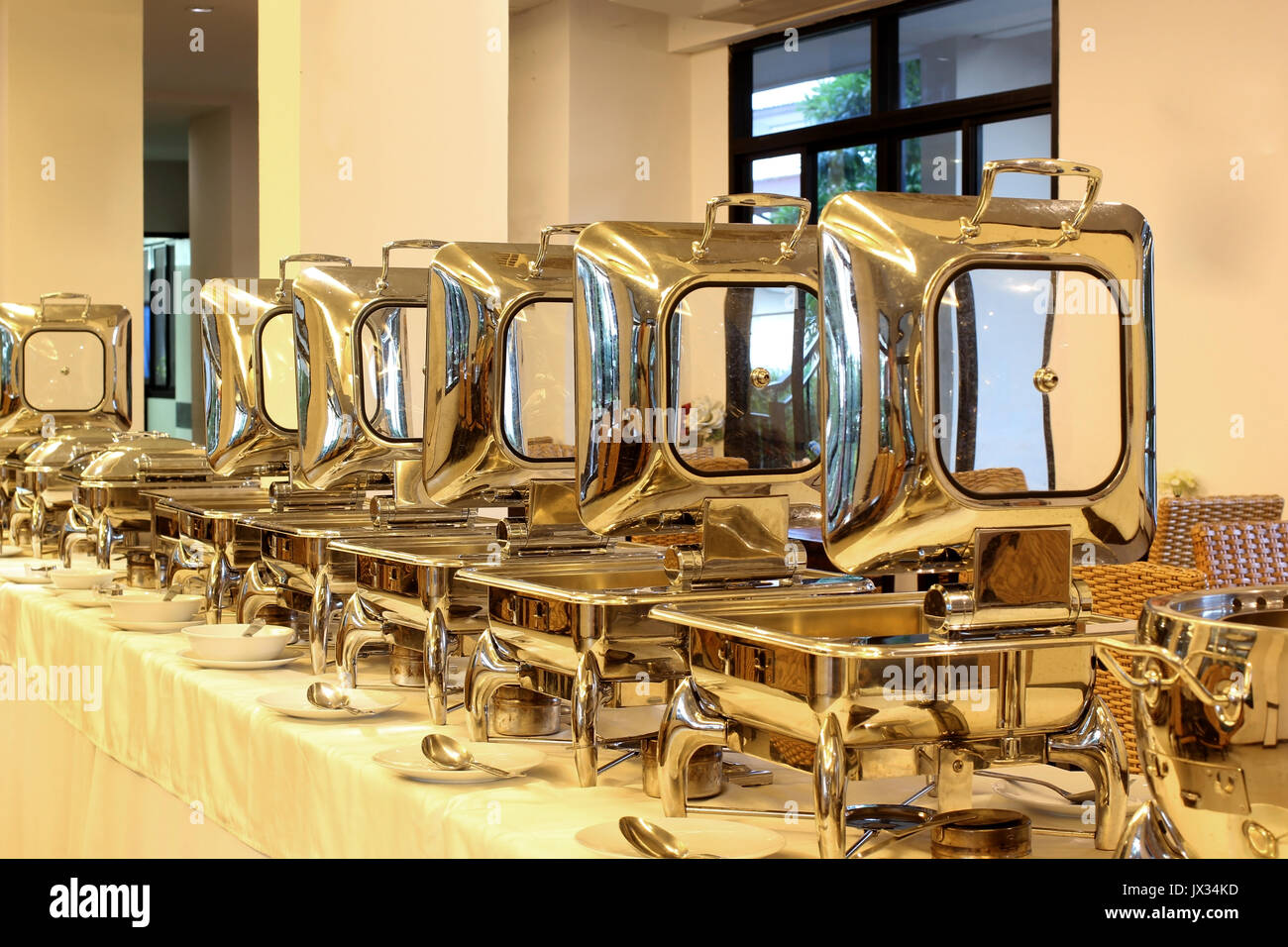 row of food service steam pans on buffet table Stock Photo