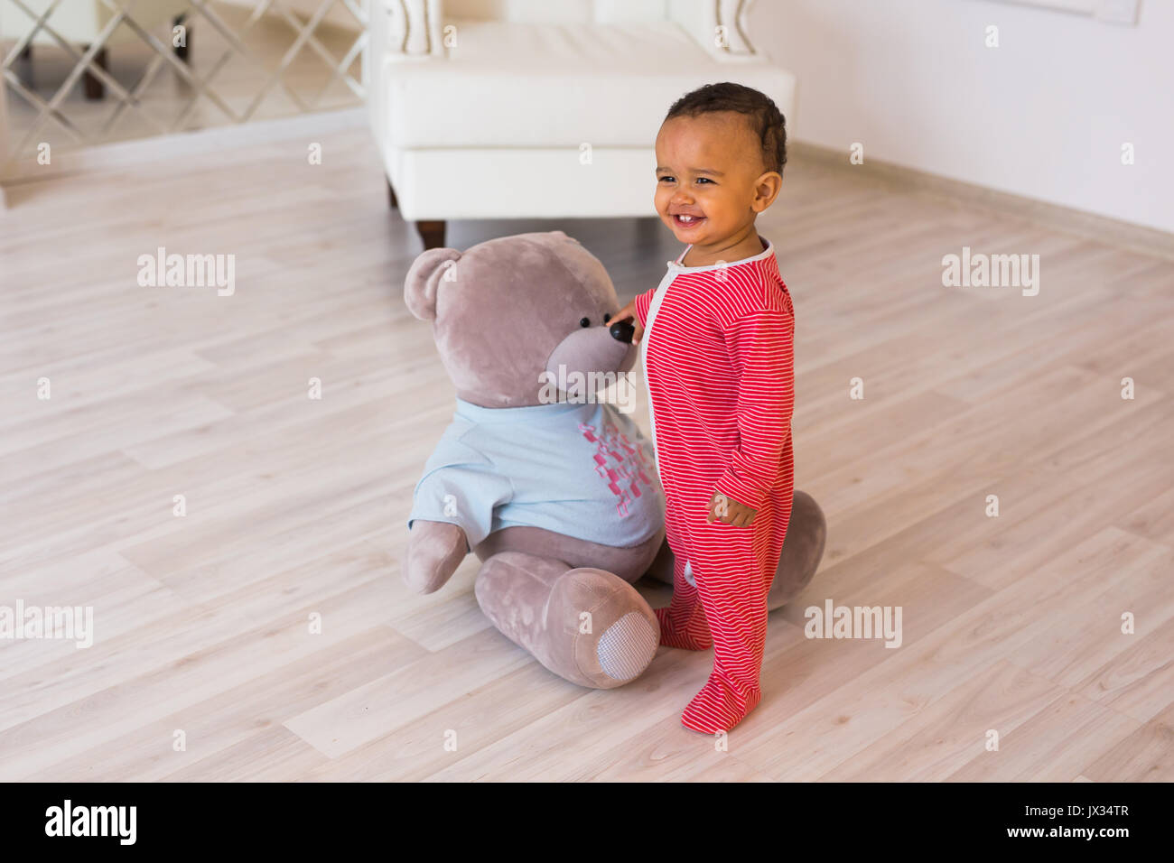 Full length portrait of mixed race baby boy in the home Stock Photo - Alamy