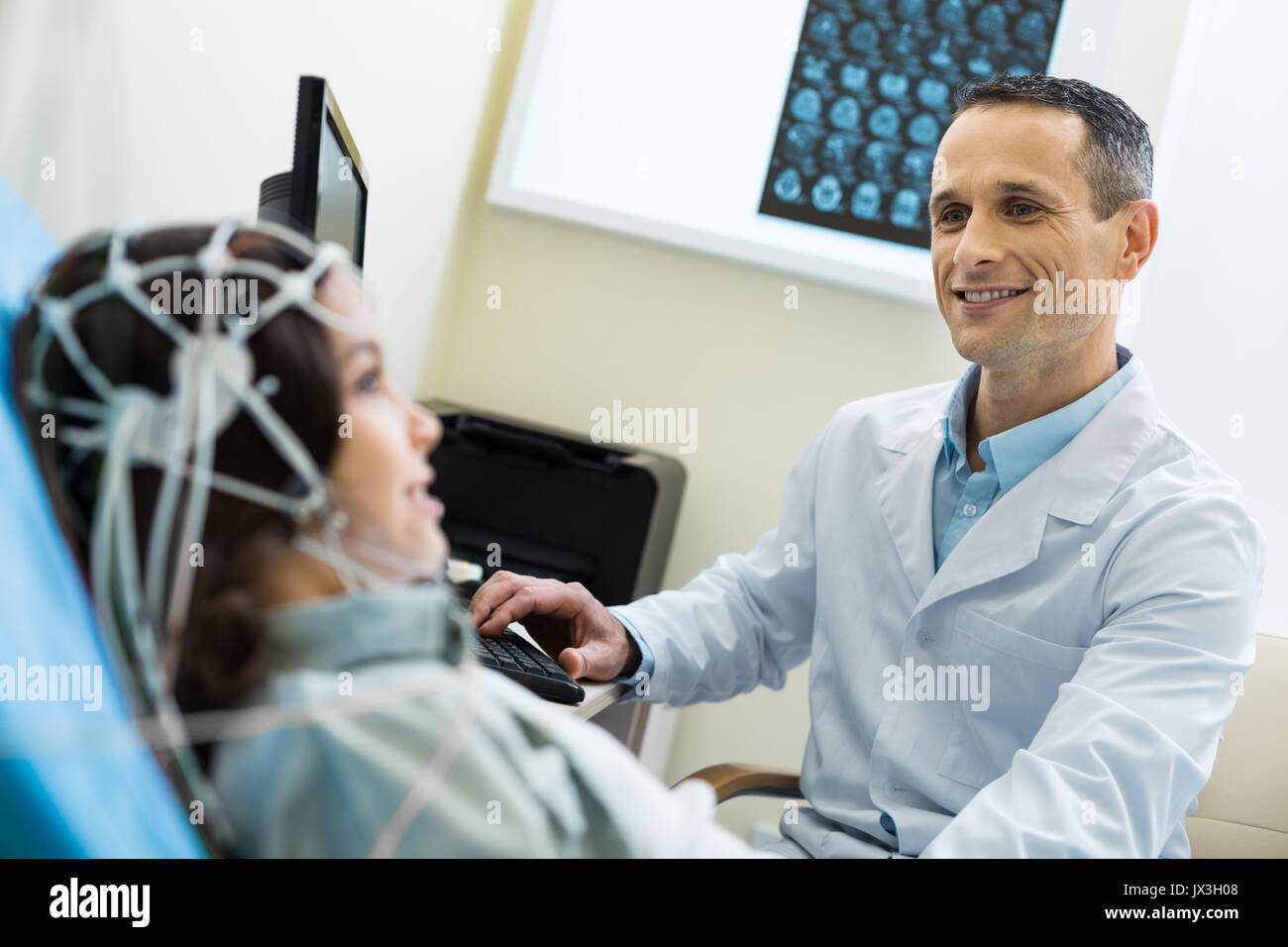 Medical specialist recording electroencephalographic waves of patients brain Stock Photo
