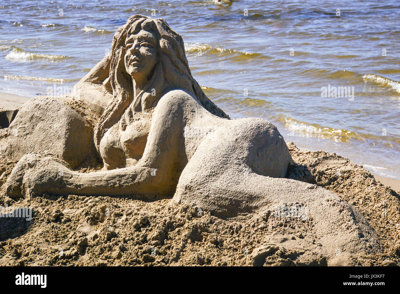 Artist makes a sand sculpture of a Mermaid. Photographed in Jurmala, Latvia Stock Photo
