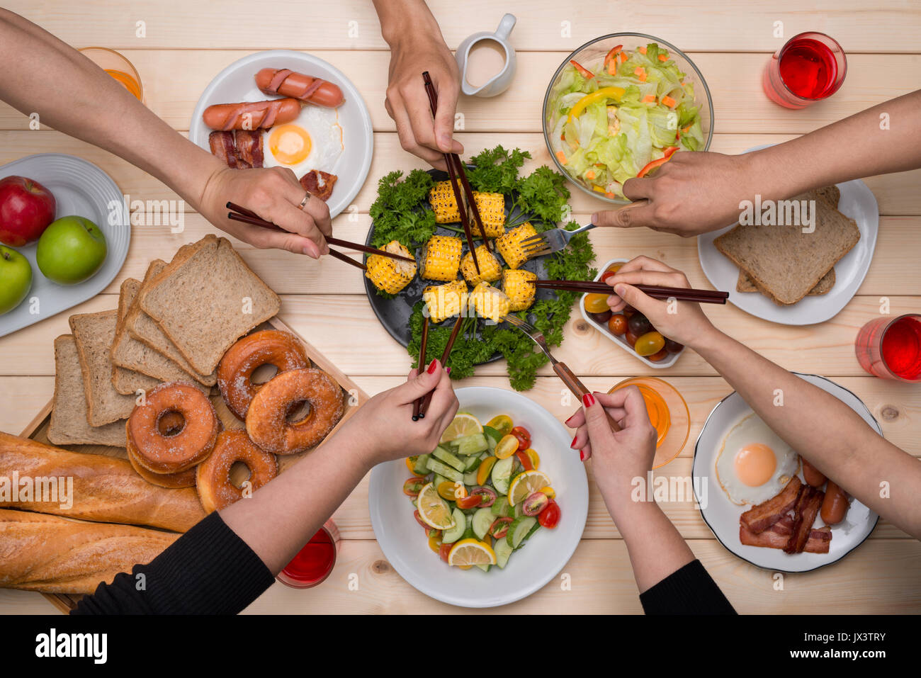 Enjoying dinner with friends. Top view of group of people having dinner