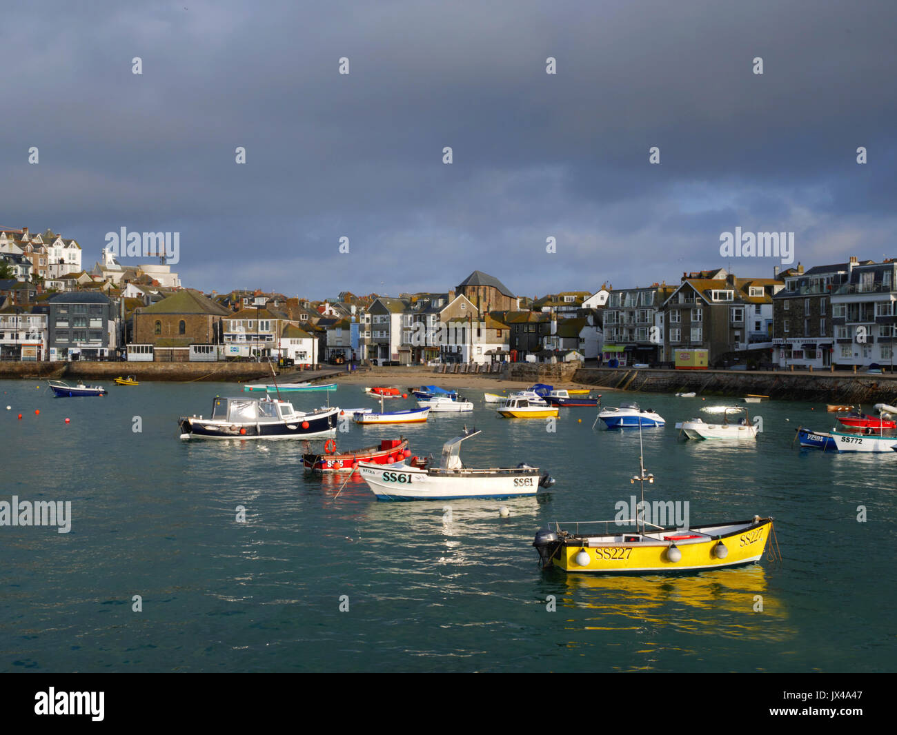 Early morning sun and stormy skies at St Ives harbour, Cornwall. Stock Photo