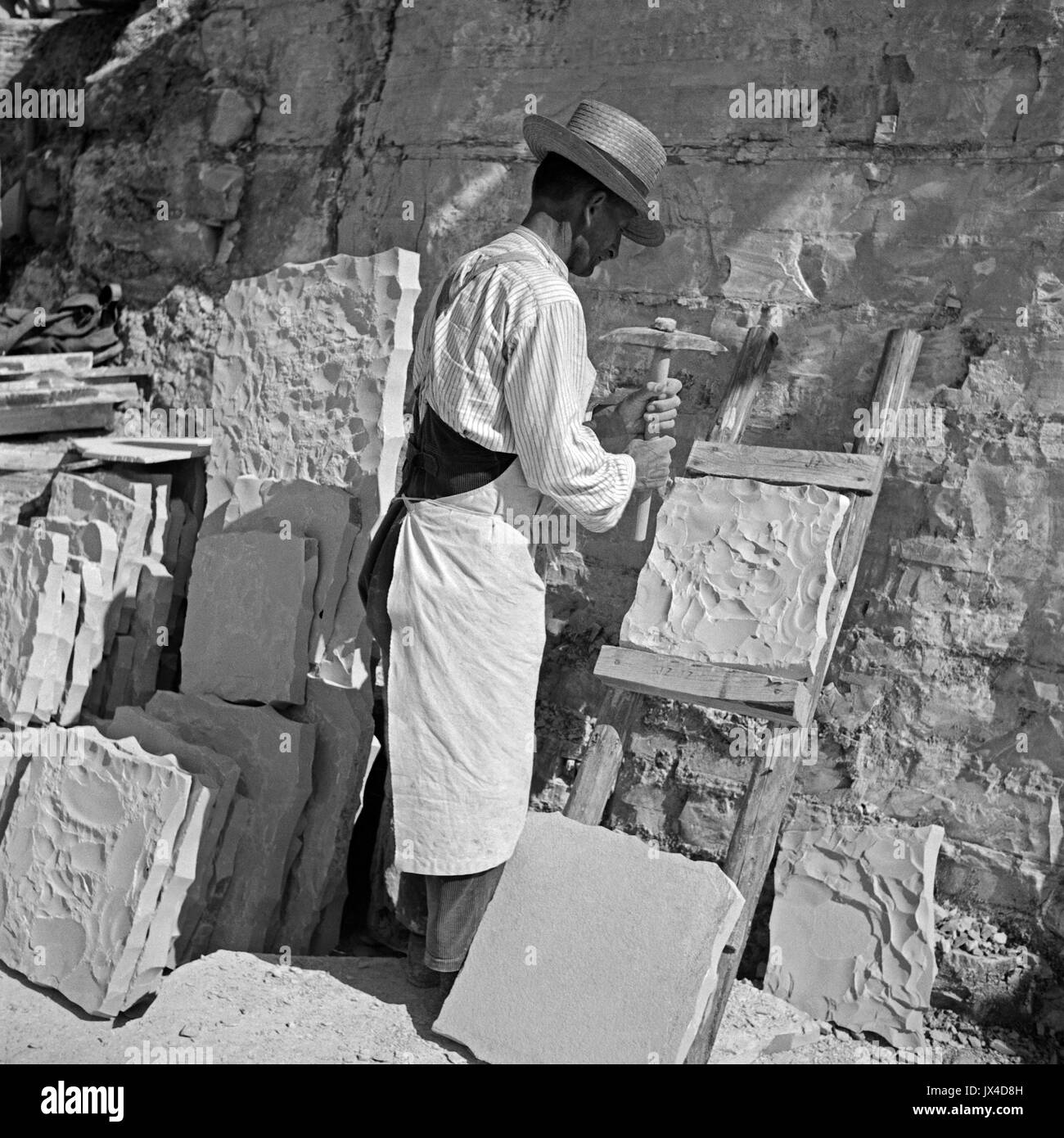 Stonemason working on slab in lithographic limestone quarry Stock Photo