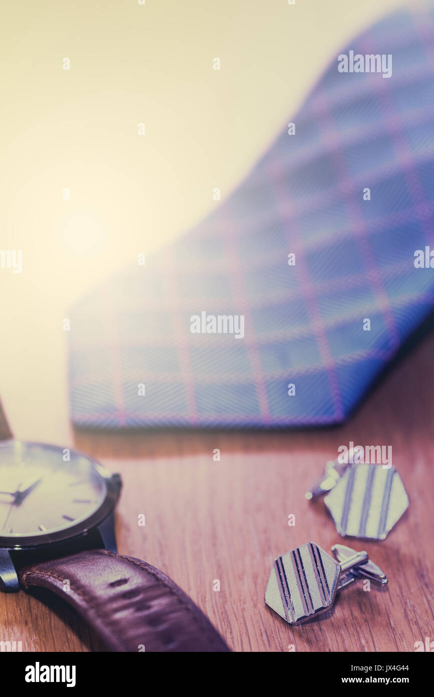 Menswear, tie, cufflinks and watch, with a vintage film look. Also see JWJ9PN. Stock Photo