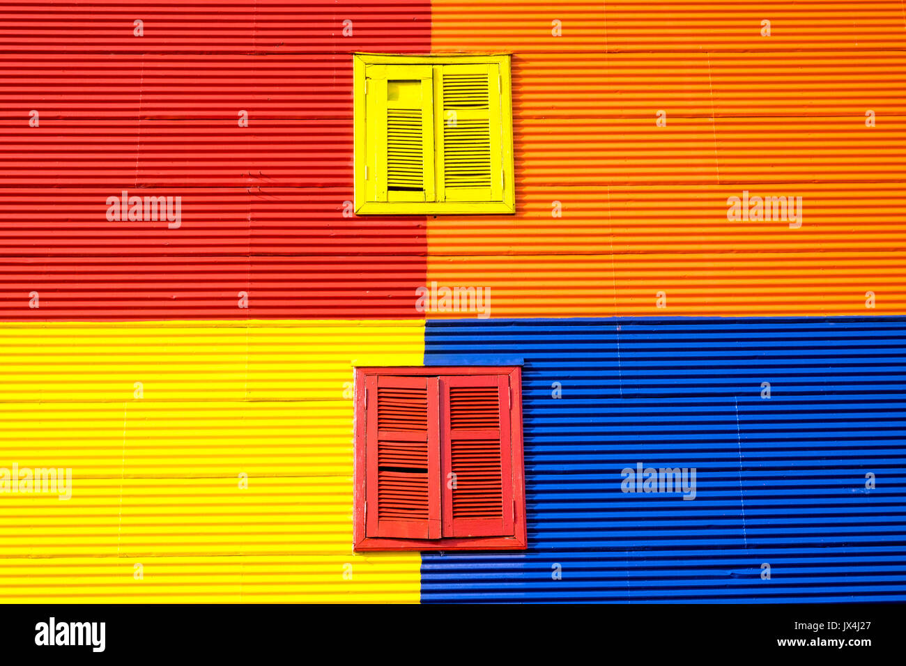 Colorful wall with two windows in La Boca, Buenos Aires Stock Photo