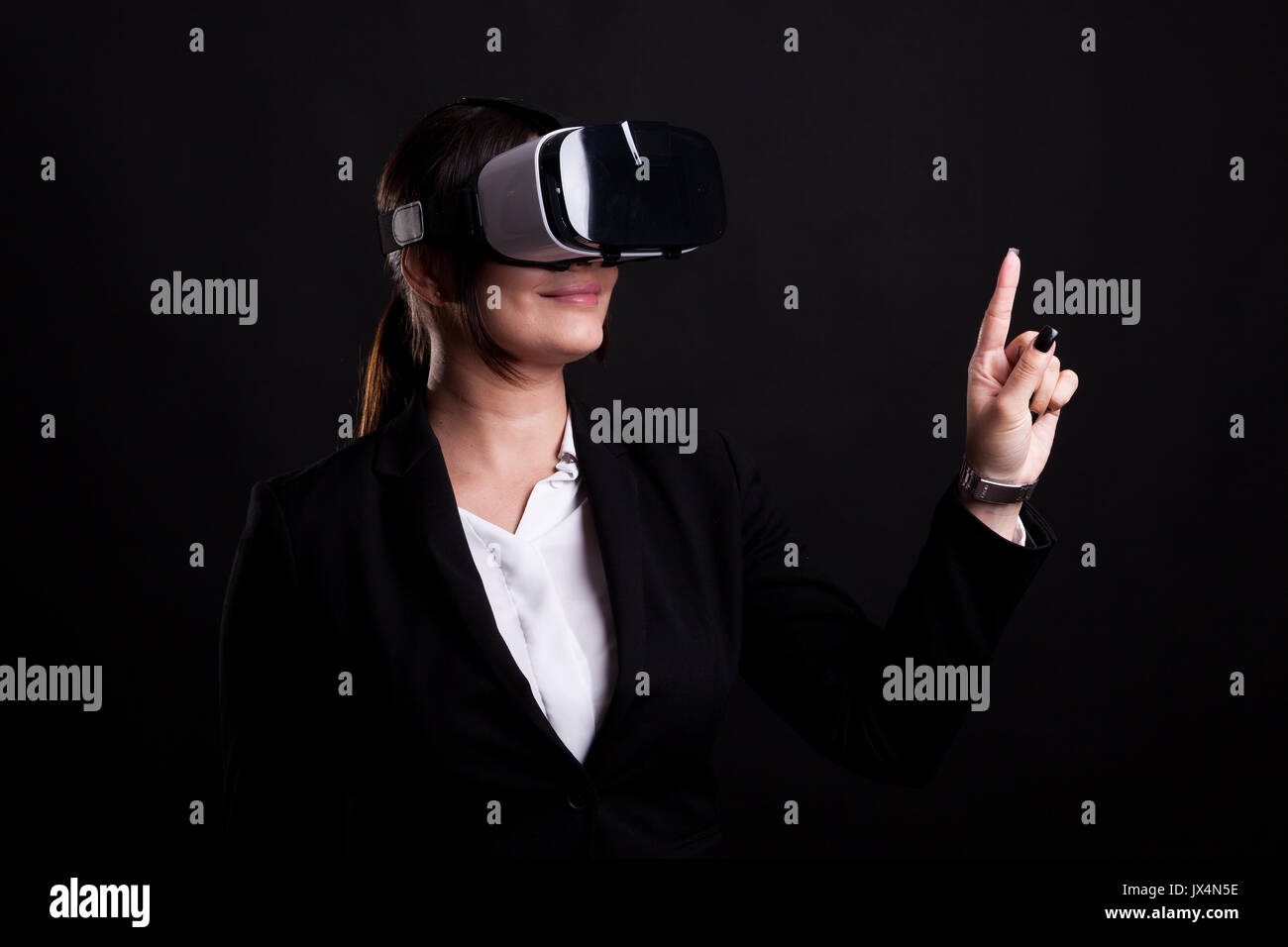 Woman in business suit wearing a VR headset Stock Photo - Alamy