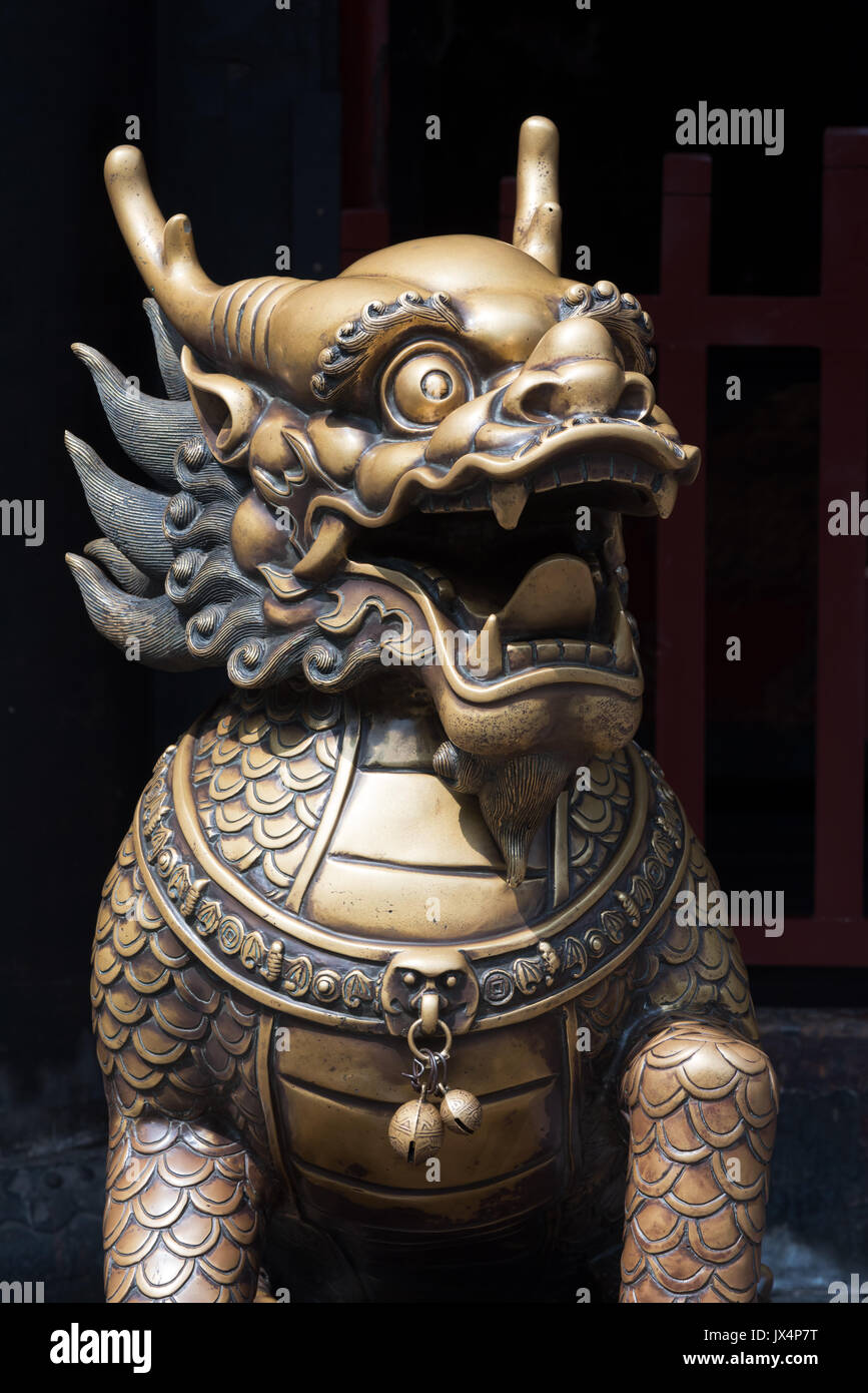 Bronze dragon head sculture at the entrance of a buddhist temple Stock