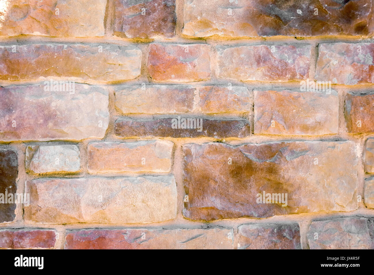 Part of the wall, built of stones bonded with cement. Stock Photo