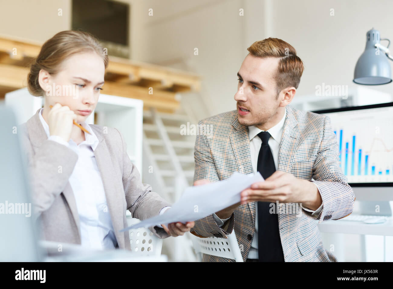 Sharing Ideas with Pretty Coworker Stock Photo