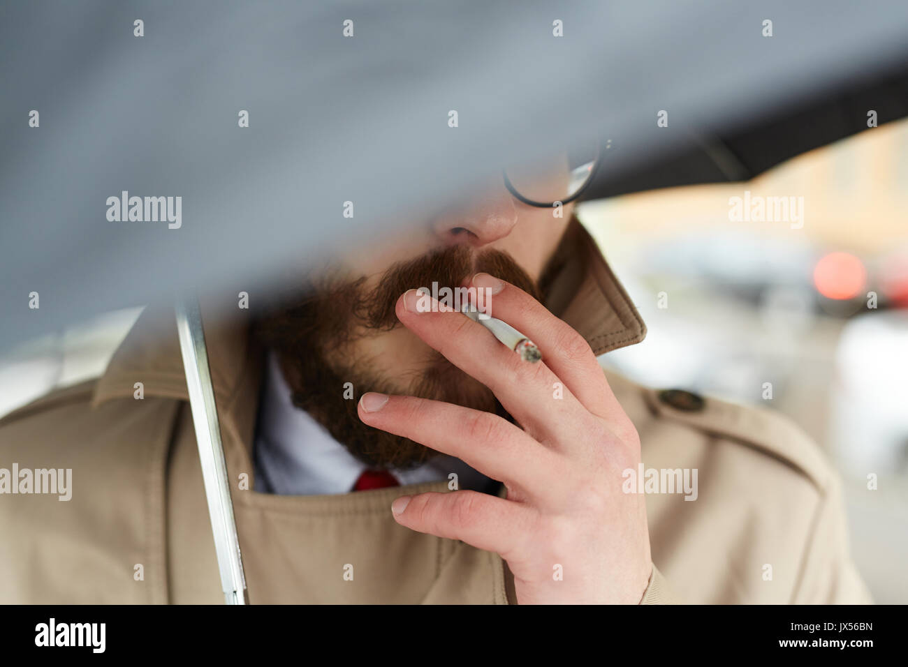 Smoking in the rain Stock Photo