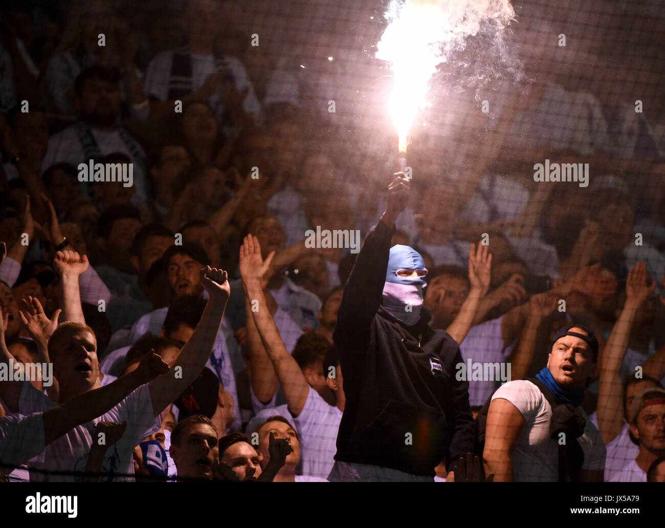 Rostock supporters ignite pyrotechnics during the German Football ...