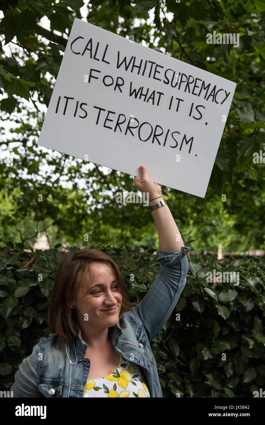 London, UK. 14th August, 2017. A supporter of Unite Against Fascism holds a sign at a vigil outside the US embassy in solidarity with anti-fascists in Charlottesville, Virginia, and in memory of Heather Heyer who was killed when a car was driven at people protesting against a white nationalist march. Credit: Mark Kerrison/Alamy Live News Stock Photo