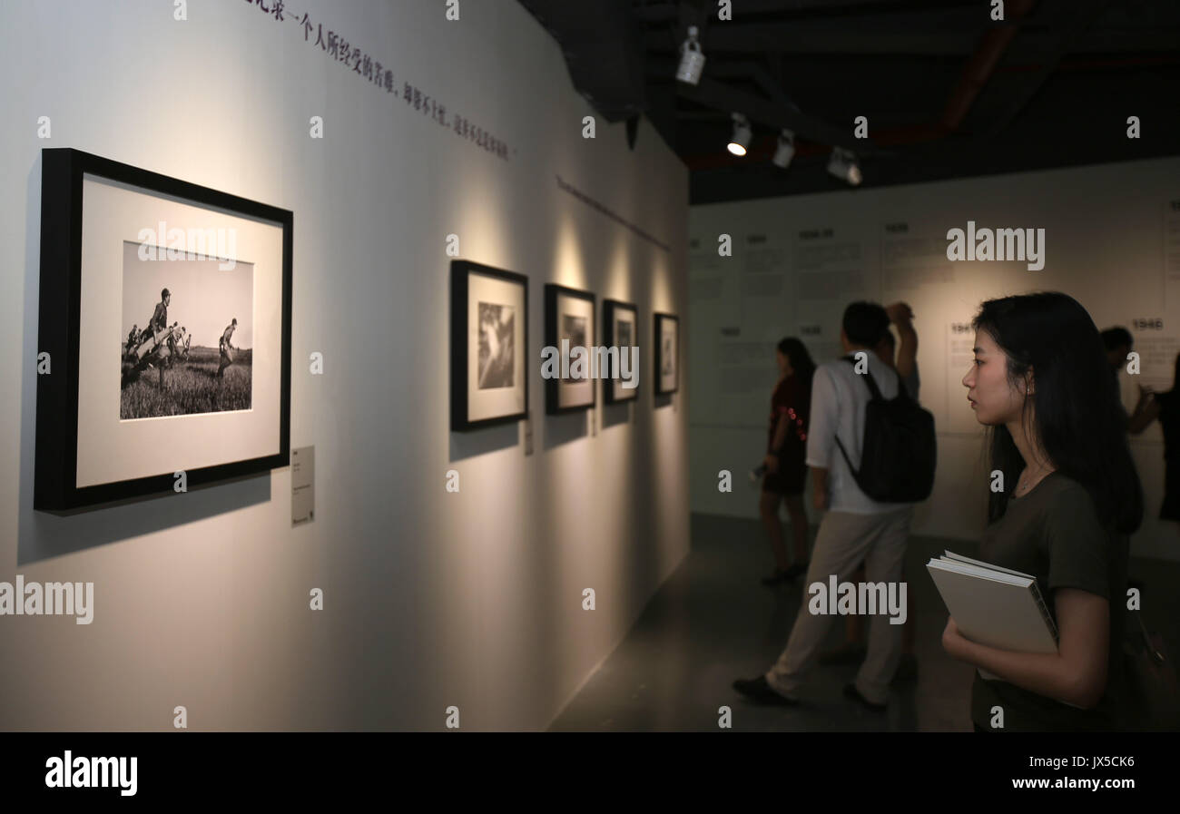 (170815) -- GUANGZHOU, Aug. 15, 2017 (Xinhua) -- People view exhibits during the Press Release of Robert Capa Retrospective Exhibition in Shenzhen, south China's Guangdong Province, Aug. 14, 2017. As the first special photography exhibition of the 4th Shenzhen International Urban Images Festival, the Press Release of Robert Capa Retrospective Exhibition kicked off in the Art Museum of Shenzhen University on Monday. Born in Hungary in 1913, Robert Capa was one of the 20th Century's most famous war photographers. He covered 5 wars of his times including the Spanish Civil War and World War II. (X Stock Photo