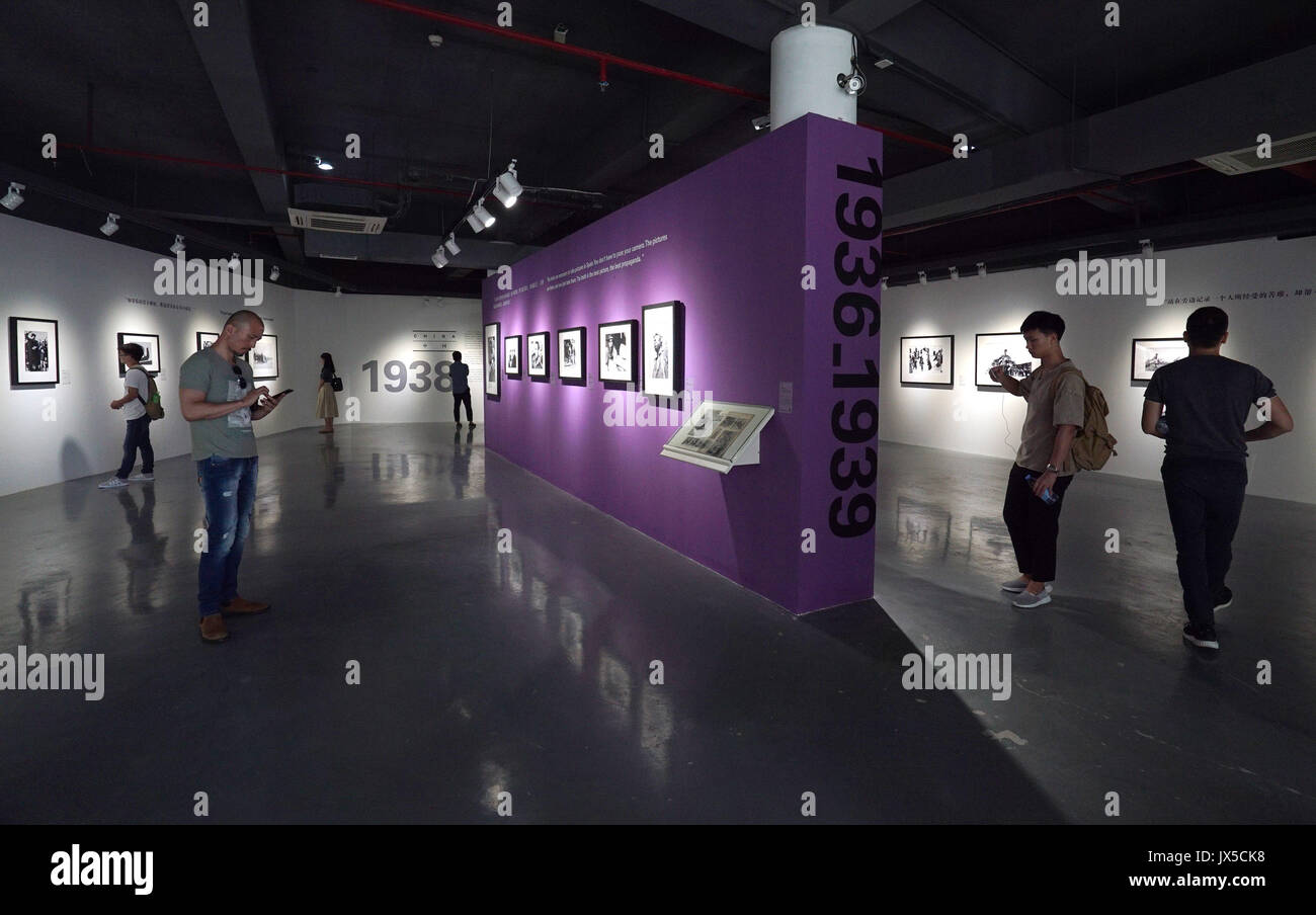 (170815) -- GUANGZHOU, Aug. 15, 2017 (Xinhua) -- People view exhibits during the Press Release of Robert Capa Retrospective Exhibition in Shenzhen, south China's Guangdong Province, Aug. 14, 2017. As the first special photography exhibition of the 4th Shenzhen International Urban Images Festival, the Press Release of Robert Capa Retrospective Exhibition kicked off in the Art Museum of Shenzhen University on Monday. Born in Hungary in 1913, Robert Capa was one of the 20th Century's most famous war photographers. He covered 5 wars of his times including the Spanish Civil War and World War II. (X Stock Photo