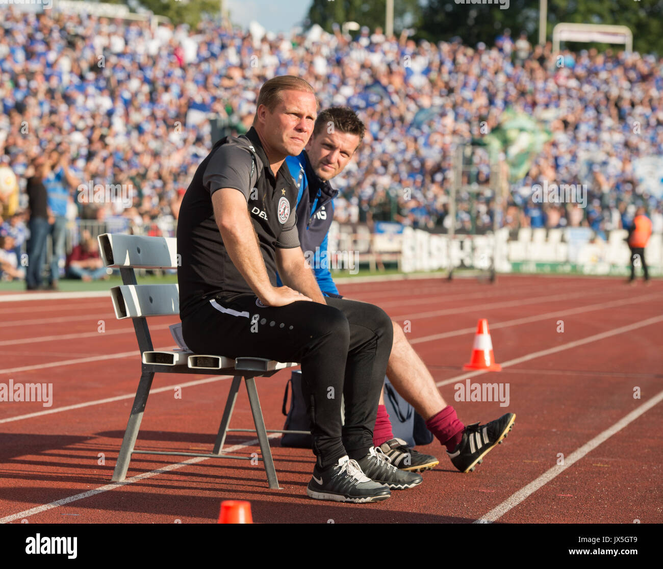 BFC Dynamo head coach Rene Rydlewicz and assistant coach Martino Gatti  (left to right) sitting on the bench during the DFB Cup match pitting BFC  Dynamo vs FC Schalke 04 in the