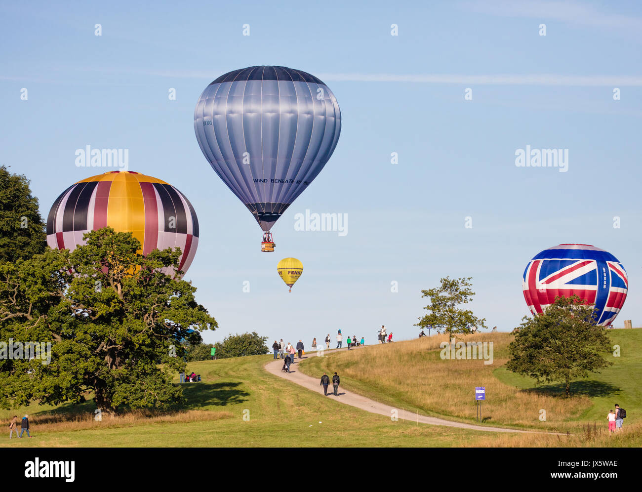 Hot air balloons landing at Ashton Court Somerset after mass ascent from the launch site during the 2017 Bristol Balloon Fiesta Stock Photo