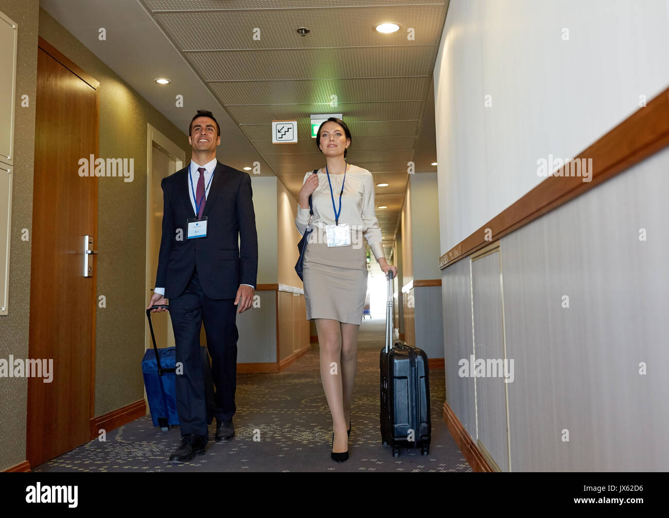 business team with travel bags at hotel corridor Stock Photo