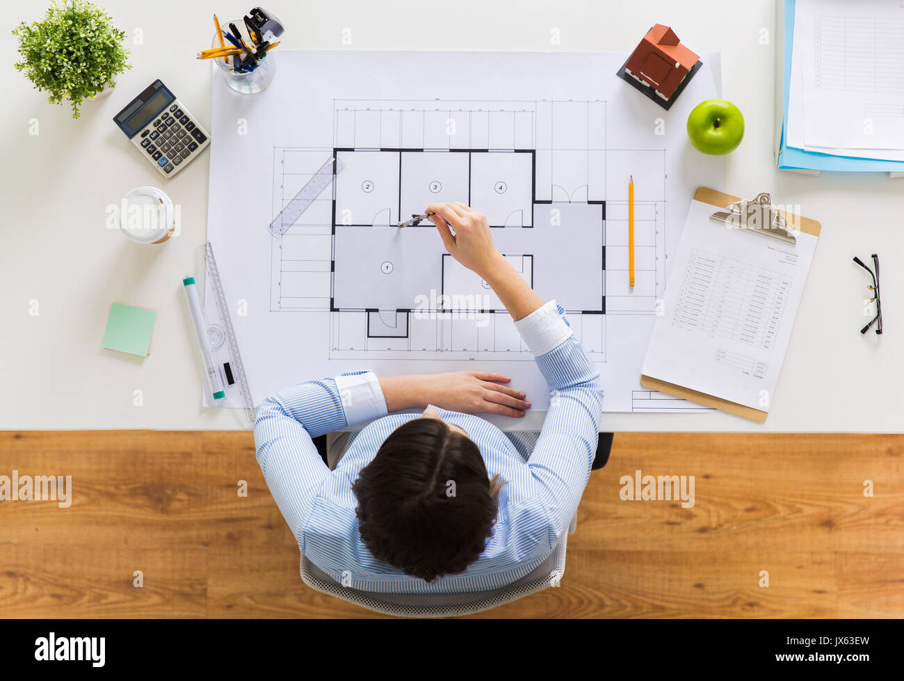 architect with compass measuring blueprint Stock Photo