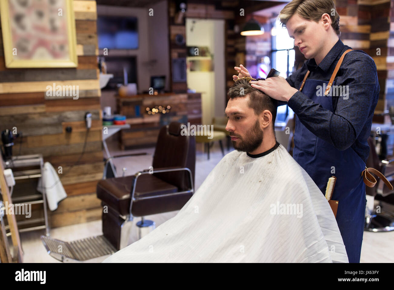 man and barber cutting hair at barbershop Stock Photo - Alamy