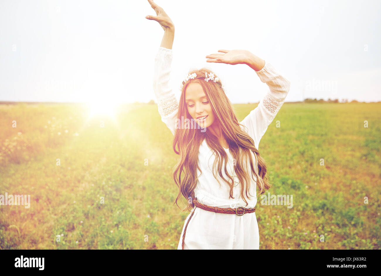 smiling young hippie woman on cereal field Stock Photo