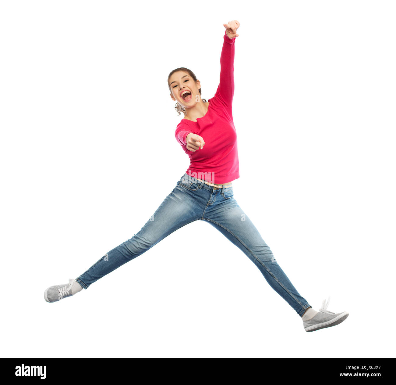 smiling young woman jumping in air Stock Photo